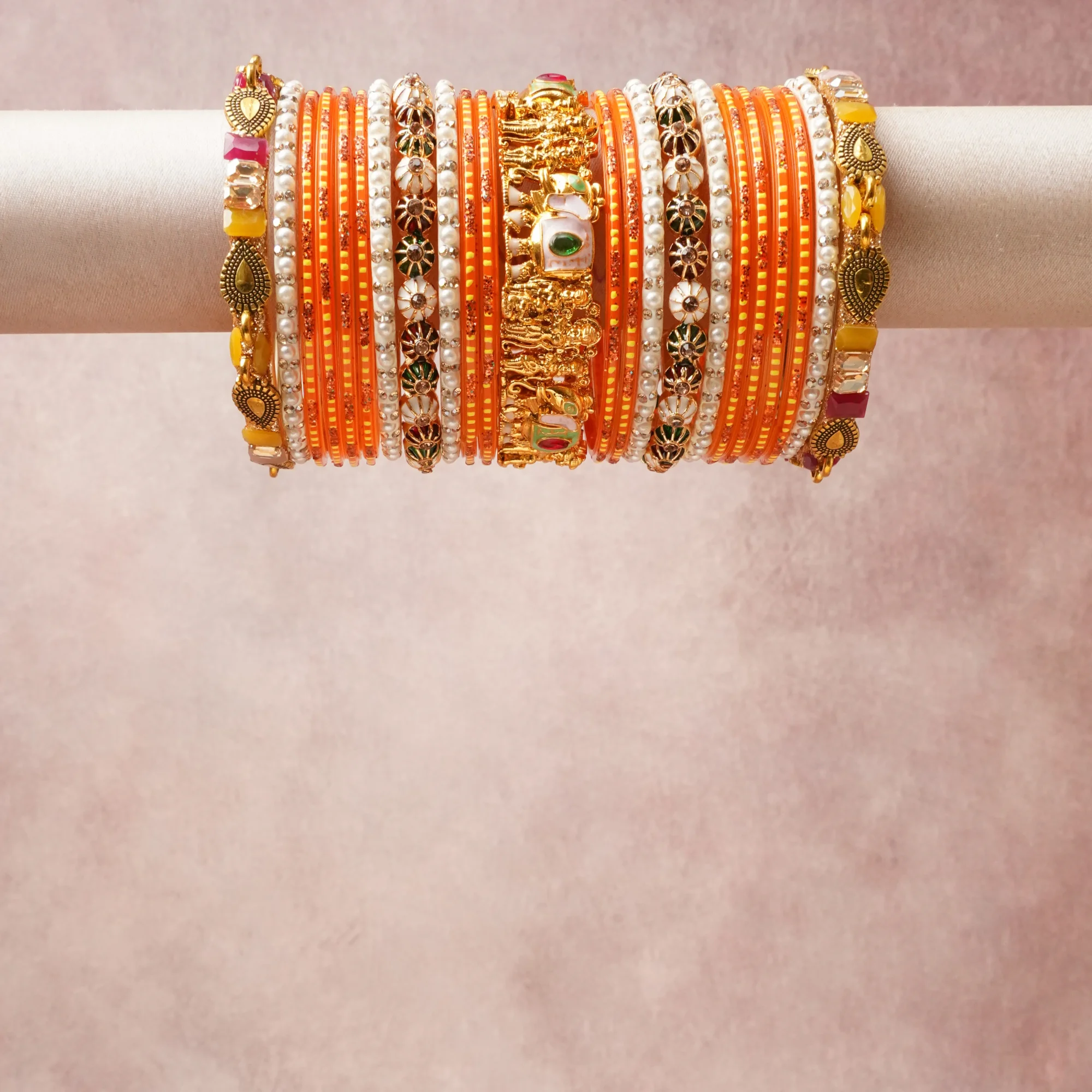 A grounding Saffron Orange forms the heart of the set, while touches of Antique Gold, Ivory Pearl, Emerald Green, Crimson Red, Rose Pink, Amber Yellow add charm.

A thoughtful composition of Glass, Gold-Plated Metal, Cultured Pearls, Enamel, Semi-Precious Gemstones, designed to feel complete without being heavy.
Each element layers seamlessly, creating a look that is refined, wearable and quietly striking.